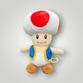 Die Bunte Box Gebrauchtwaren Super Mario Toad Plüschfigur mit rotem und weißem Pilzhut und blauer Weste.