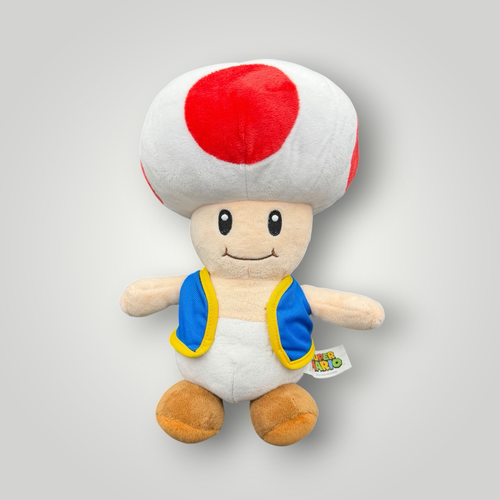 Die Bunte Box Gebrauchtwaren Super Mario Toad Plüschfigur mit rotem und weißem Pilzhut und blauer Weste.